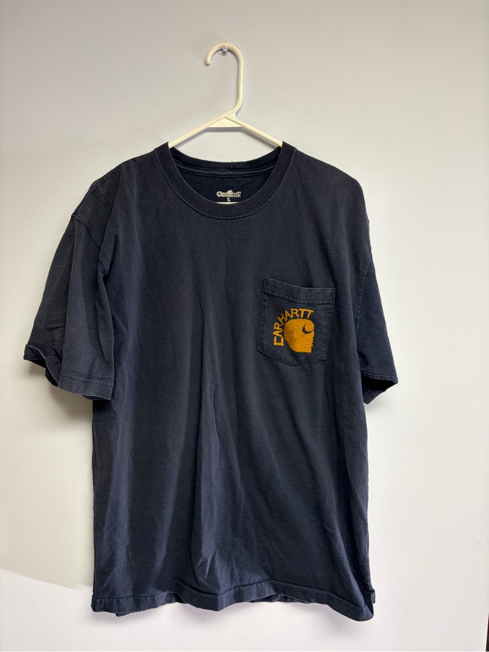 Vintage well-worn Carhartt Men’s Pocket T-Shirt in Navy with Yellow Logo